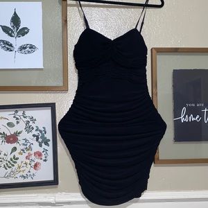 Tight ruffled black dress. Breast are padded for that extra lift!